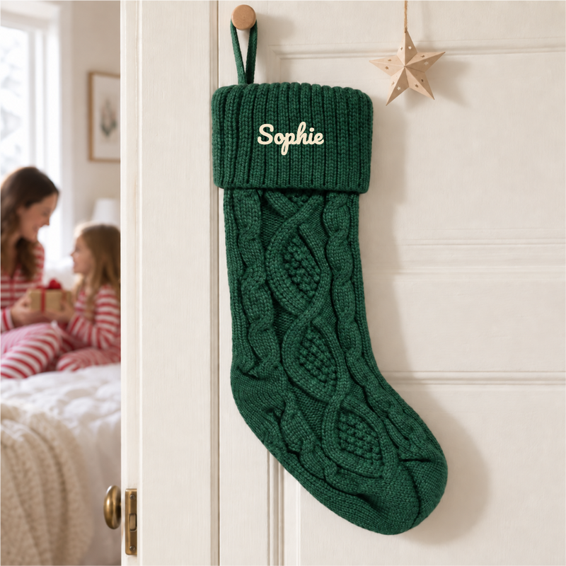 Green Knit Christmas Stocking with Embroidered Name shot as a still life, on a clean surface in daylight