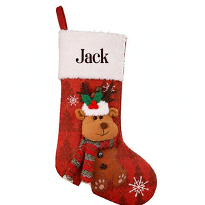 Close-up of the personalized red stocking showing the fur cuff, the name in dark letters, the full body and the plush reindeer sewn to the front