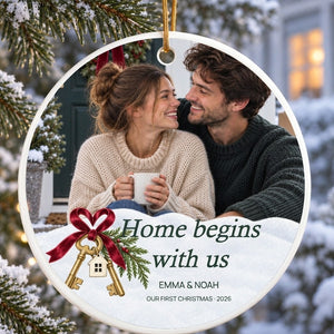 Close-up of the personalized first home Christmas ornament: the polished acrylic edge, the gold cord above it, and the print seen through the disc