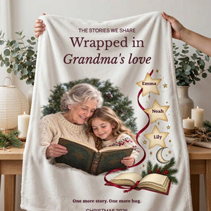 Two hands holding up the personalized fleece blanket for Grandma in a bright room