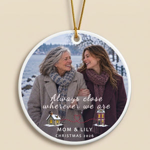 Close-up of the personalized long distance ornament for Mom: the polished acrylic edge, the gold cord above it, and the print seen through the disc