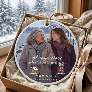 Personalized long distance ornament for Mom resting in an open kraft gift box lined with ivory tissue paper